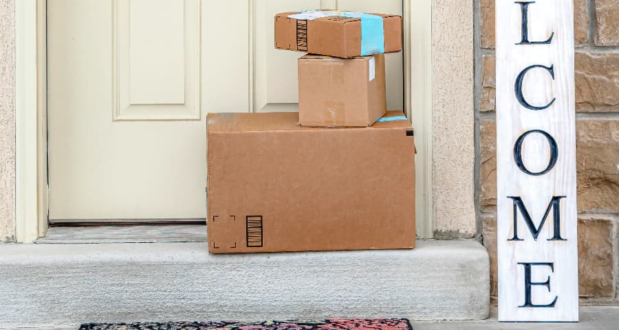 Boxes by the door of a residence with a welcome sign in Fort Lauderdale